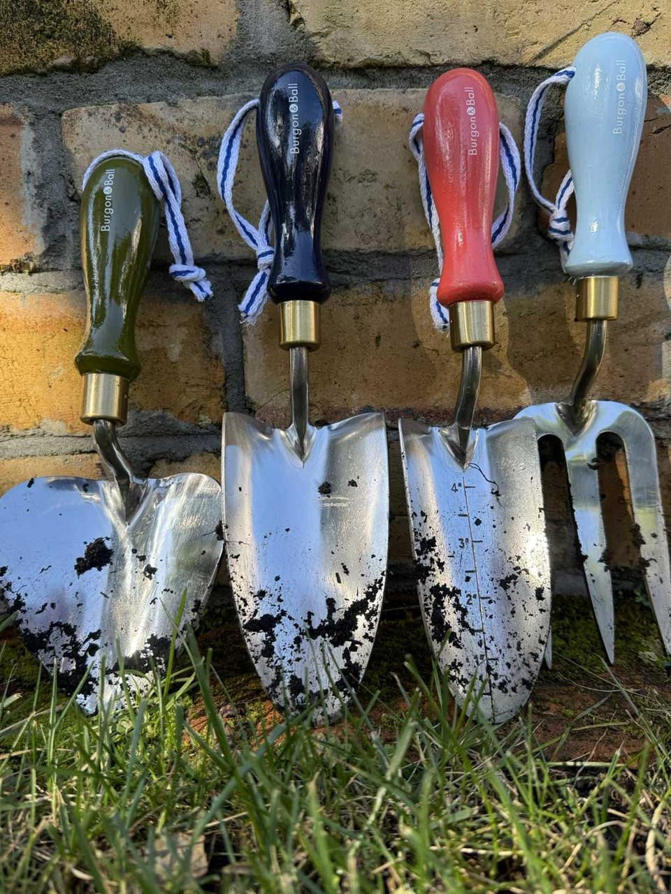 Navy Burgon & Ball Collector Hand Trowel with wooden handle for gardening and planting tasks.