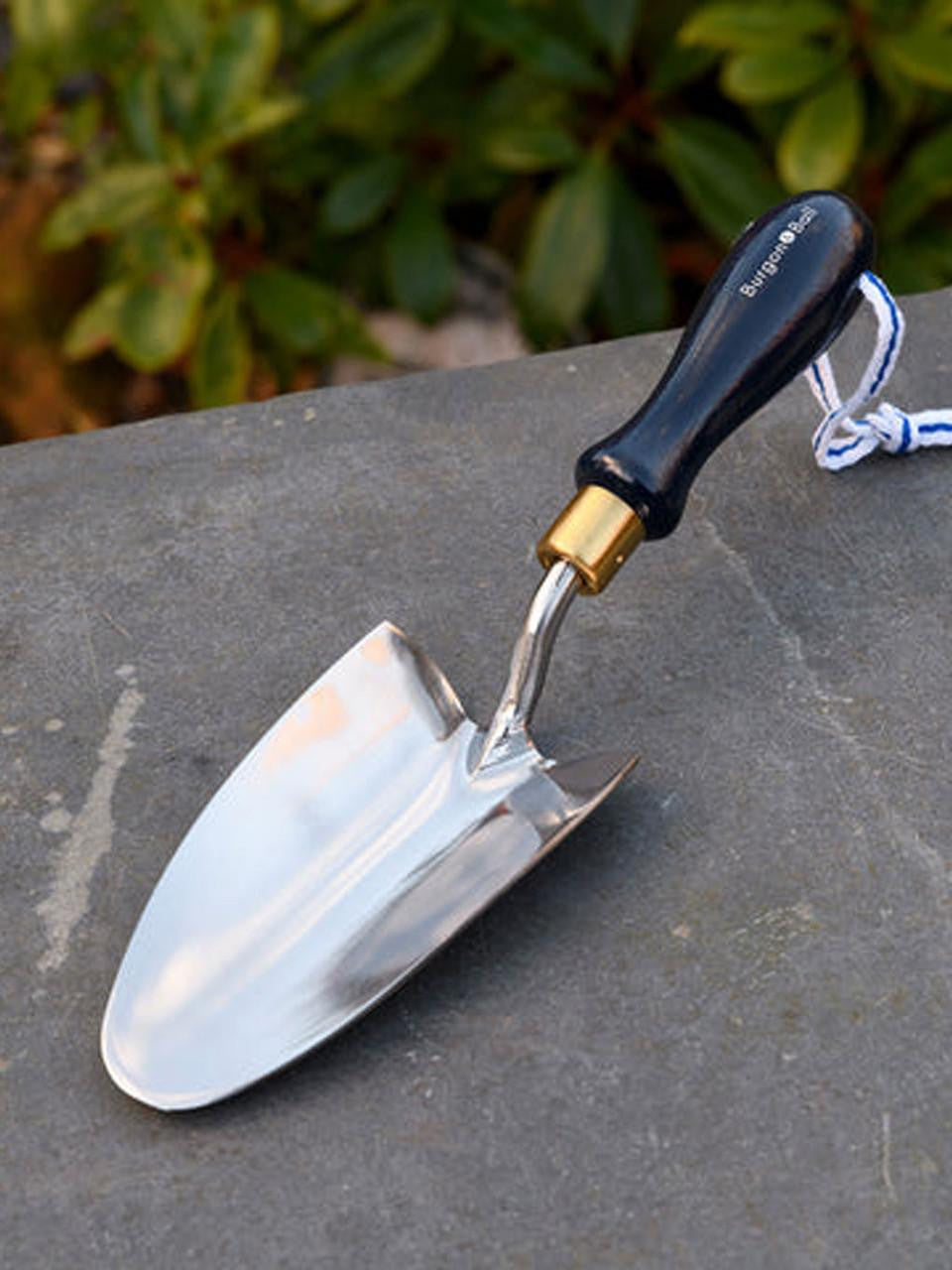 Navy collector hand trowel by Burgon & Ball with a wooden handle and metal blade, ideal for gardening and planting tasks.