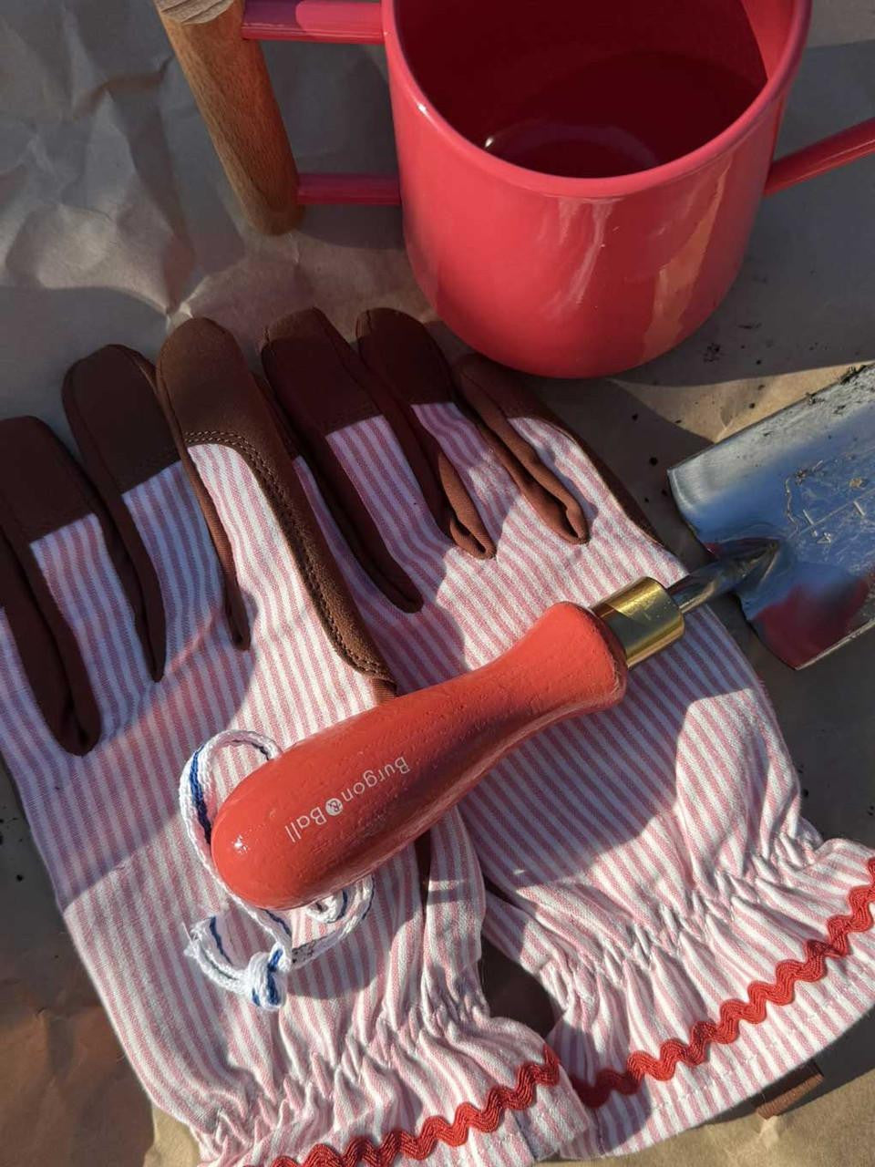 Indoor watering can by Burgon & Ball in coral color, with a sleek design and a long spout for easy watering.