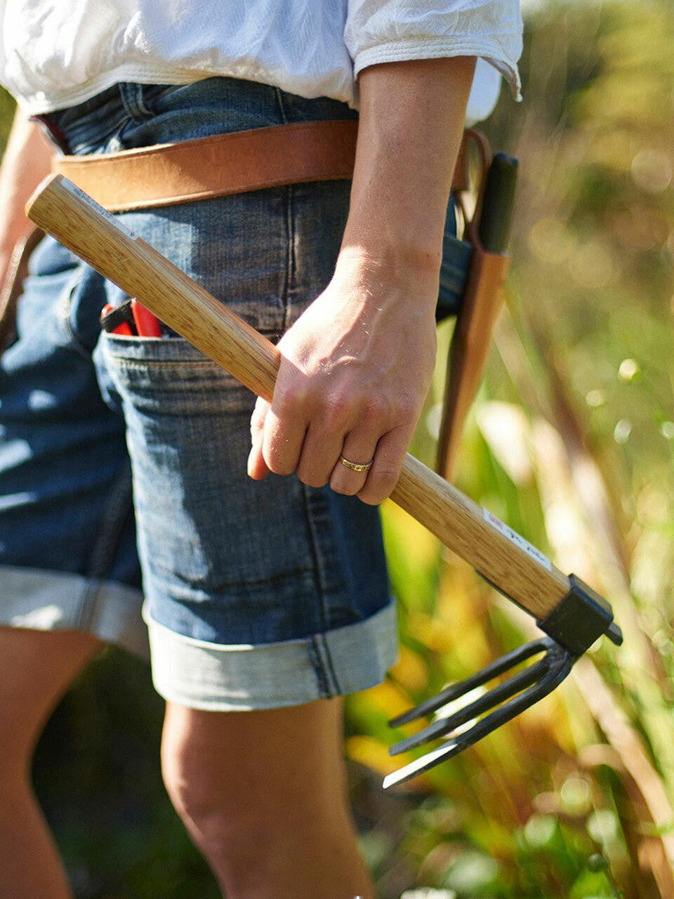 Forked Hand Hoe by Elephant Tools with a wooden handle and metal forked blade, ideal for gardening and soil cultivation.