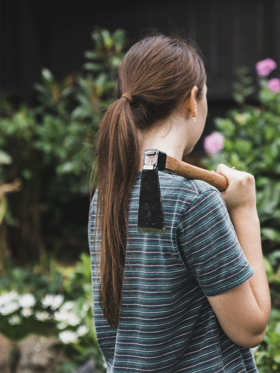 Elephant Tools hand hoe with wooden handle and metal blade for gardening and soil cultivation.