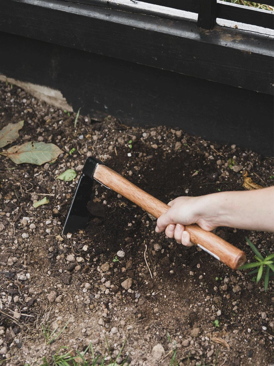 Elephant Tools hand hoe with wooden handle and metal blade, ideal for gardening and soil cultivation.