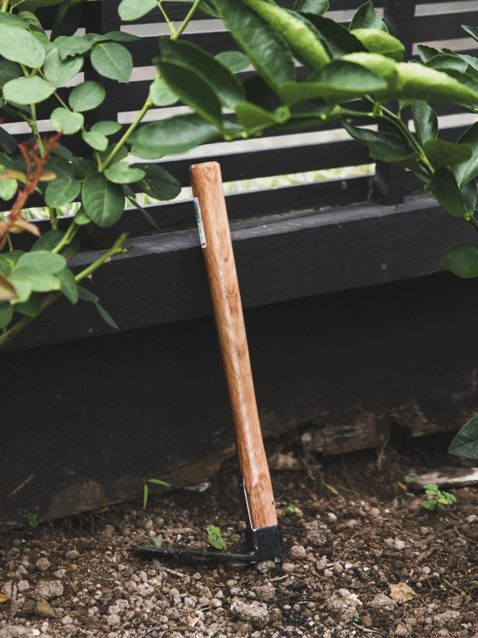 Elephant Tools hand hoe with wooden handle and metal blade for gardening and soil cultivation.