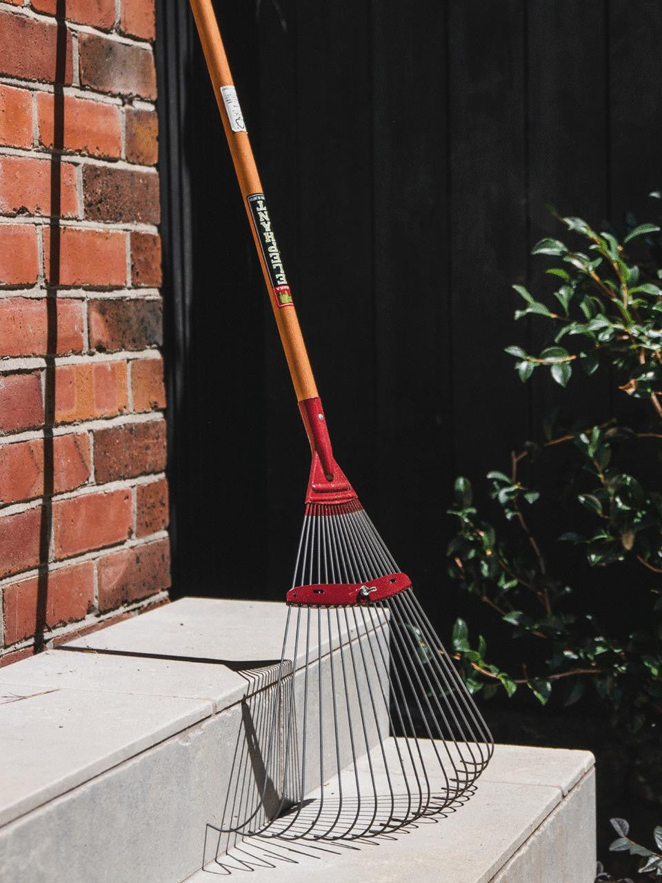 Elephant Tools rake with metal tines and wooden handle for gardening and yard work.