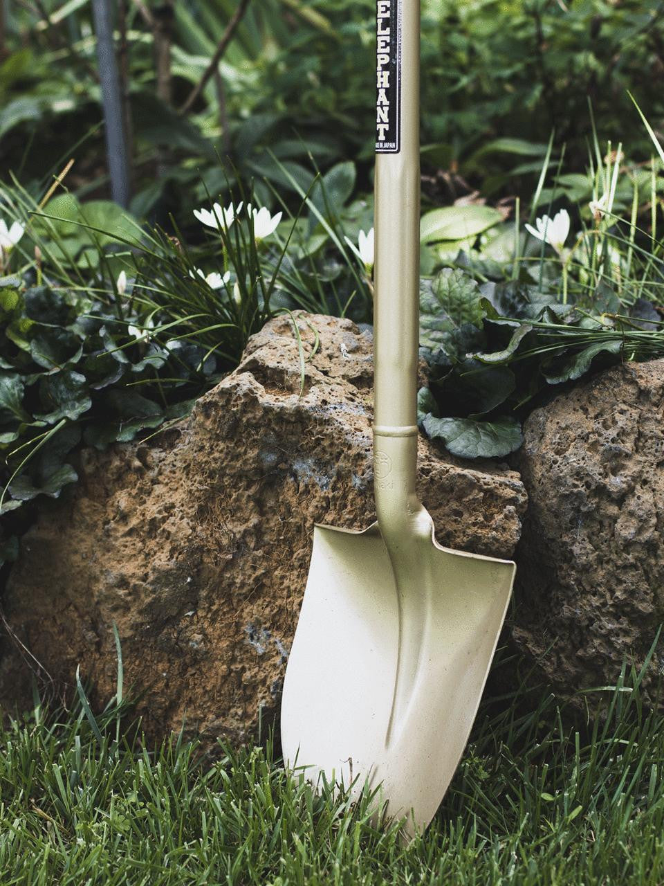 Small golden spade from Elephant Tools with a sturdy handle and shiny metal blade, ideal for gardening and digging tasks.
