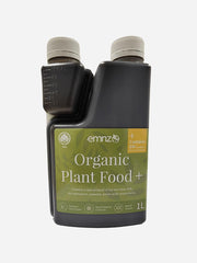 Organic plant food by EMNZ, showing a close-up of the nutrient-rich fertilizer granules in a natural setting.