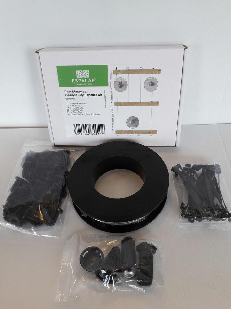 Post mounted Espalar espalier kit with wire for garden training, featuring wooden posts and metal wire for fruit or plant support.