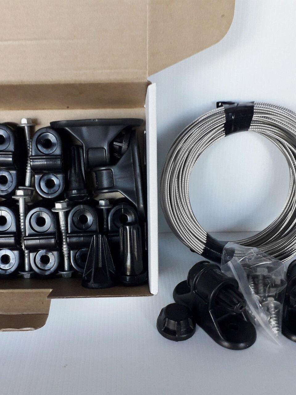 Surface mounted universal espalier kit with wire by Espalar, featuring metal components for garden fruit tree training.