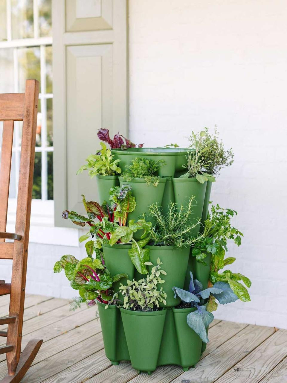 Three-tier GreenStalk vertical planter with lush evergreen plants in a modern design for outdoor gardening.