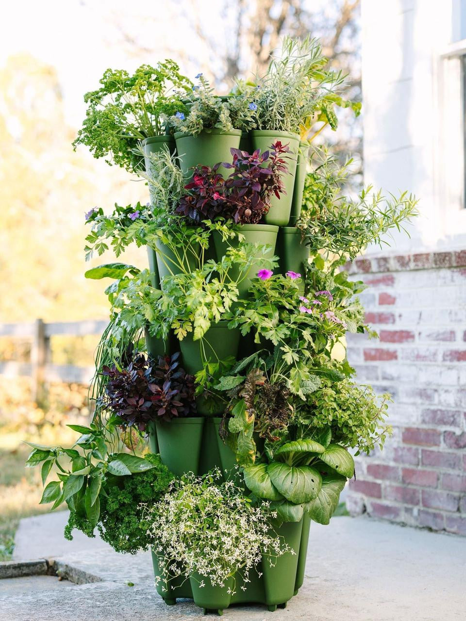 GreenStalk 5 Tier Original Vertical Planter in evergreen with multiple planting tiers and lush green foliage.