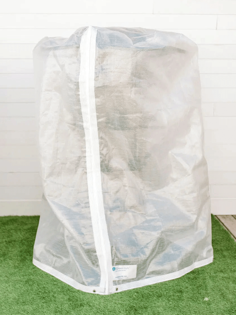 GreenStalk insect protection cover showing mesh material draped over plant containers for pest prevention.