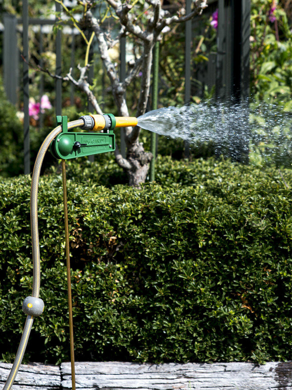 Dugard Hose Holder mounted on wall for keeping garden hoses tidy and tangle-free — Bugg