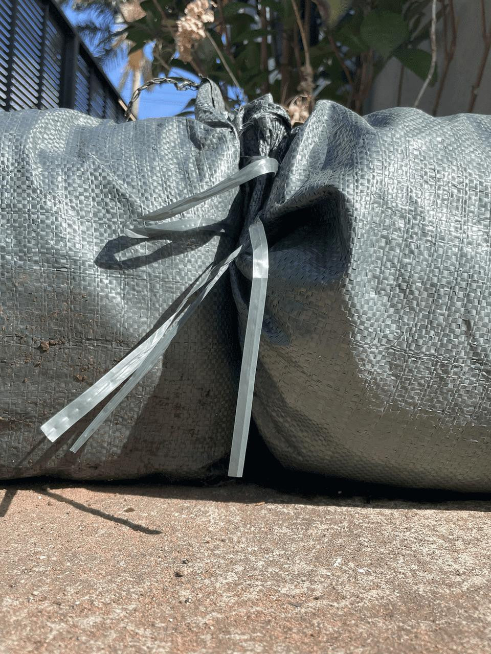 Sandbag in green, durable fabric bag for garden use and outdoor stability — Bugg