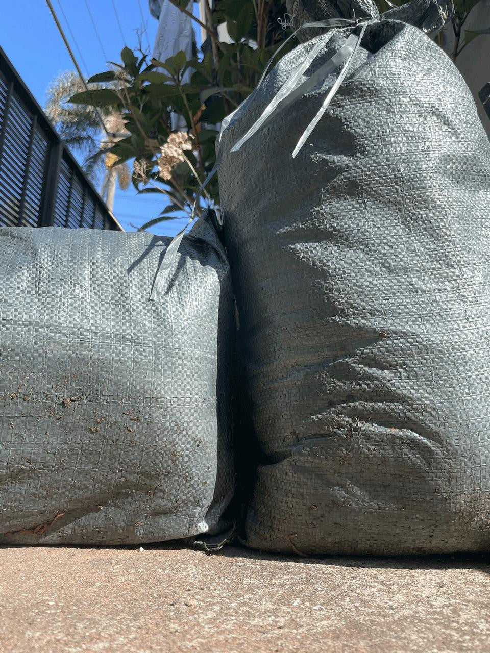 Sandbag in green with handles for easy repositioning around the garden — Bugg