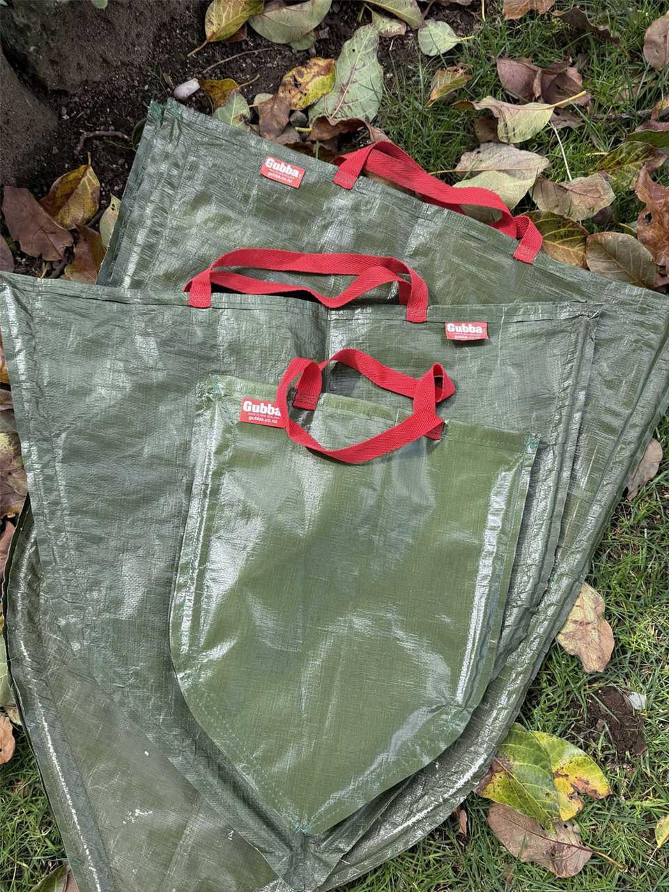 Red Gubba Anything Bag with adjustable strap and multiple compartments for versatile storage and organization.