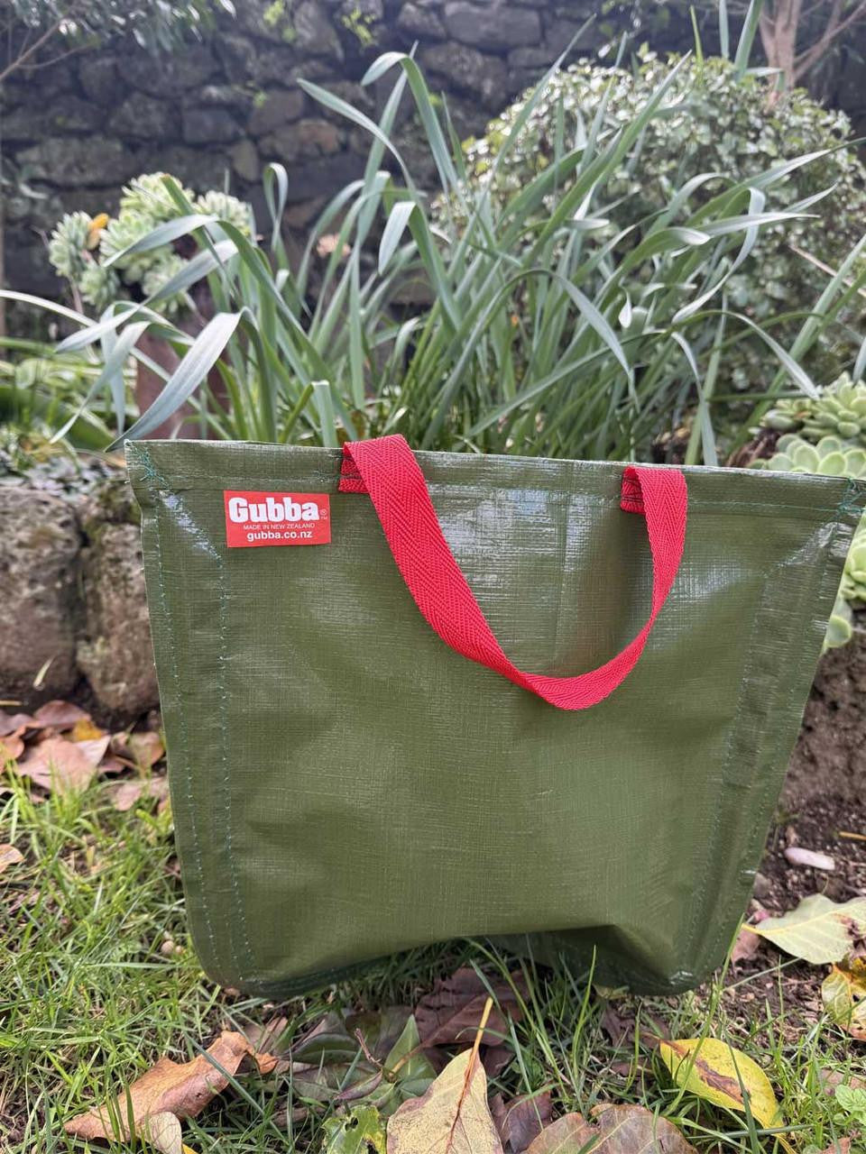 Red Gubba Anything Bag with adjustable straps and multiple compartments, designed for versatile storage and everyday use.