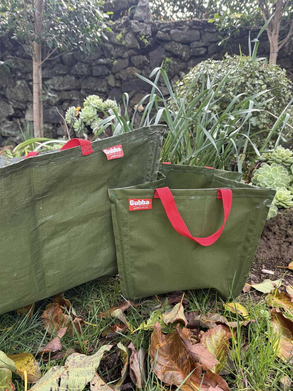 Red Gubba Anything Bag showing a spacious, versatile bag with multiple compartments and adjustable straps.