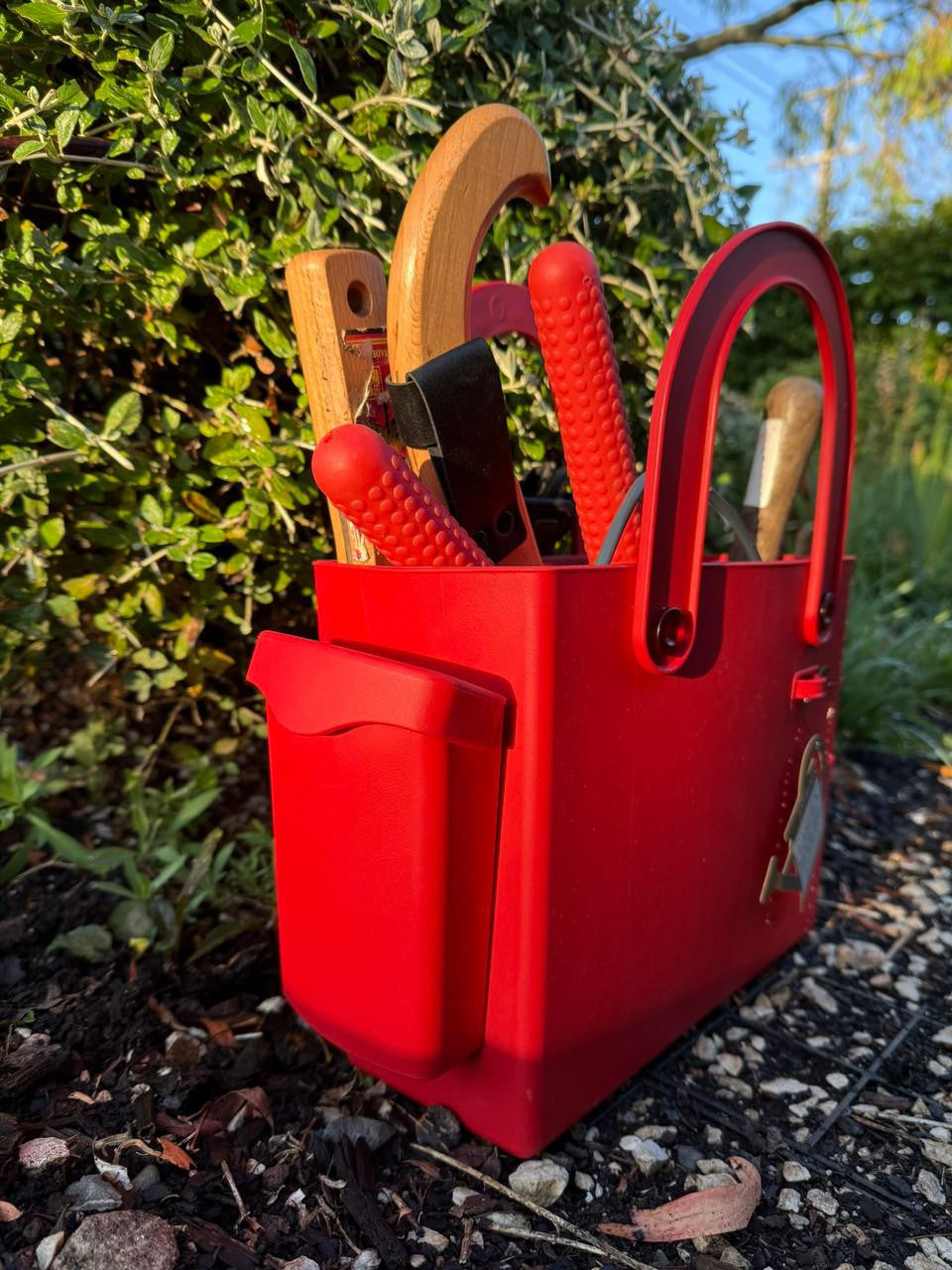 Red Hachiman garden tool bag with multiple compartments and sturdy handles for outdoor gardening and tool organization.