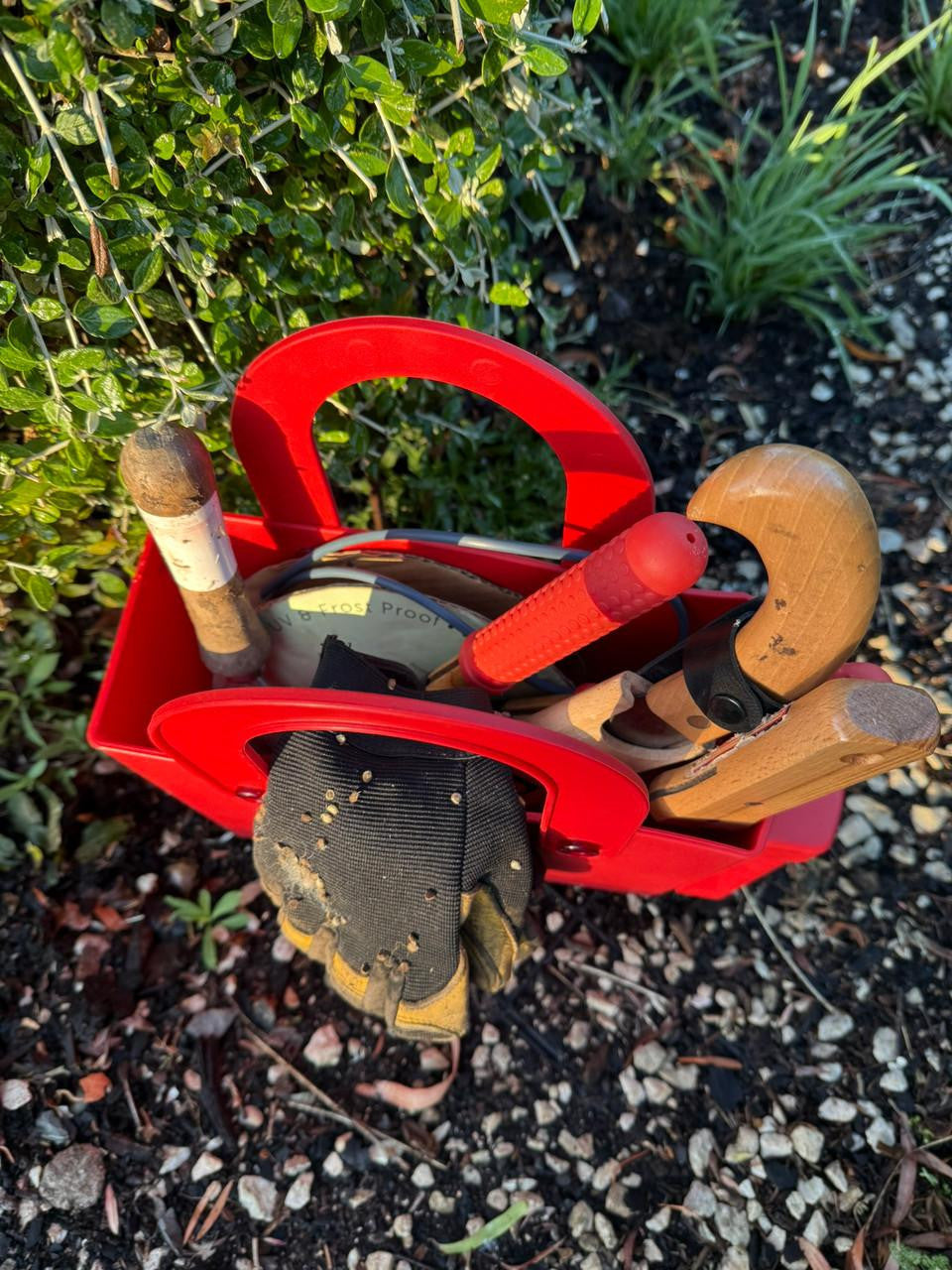 Red Hachiman garden tool bag with multiple pockets and handles, designed for organizing and carrying gardening tools.