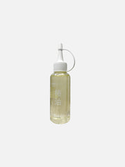 Bottle of Kamaki Camellia Oil with dropper cap, showcasing clear liquid in a sleek container, ideal for hair and skin care.
