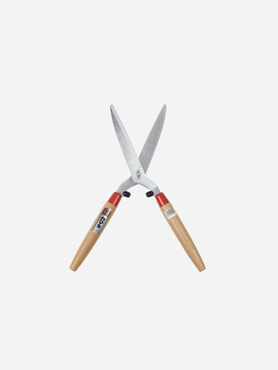 Kamaki Hedge Shears 1050 with ergonomic handles for precise pruning of hedges and shrubs in garden.