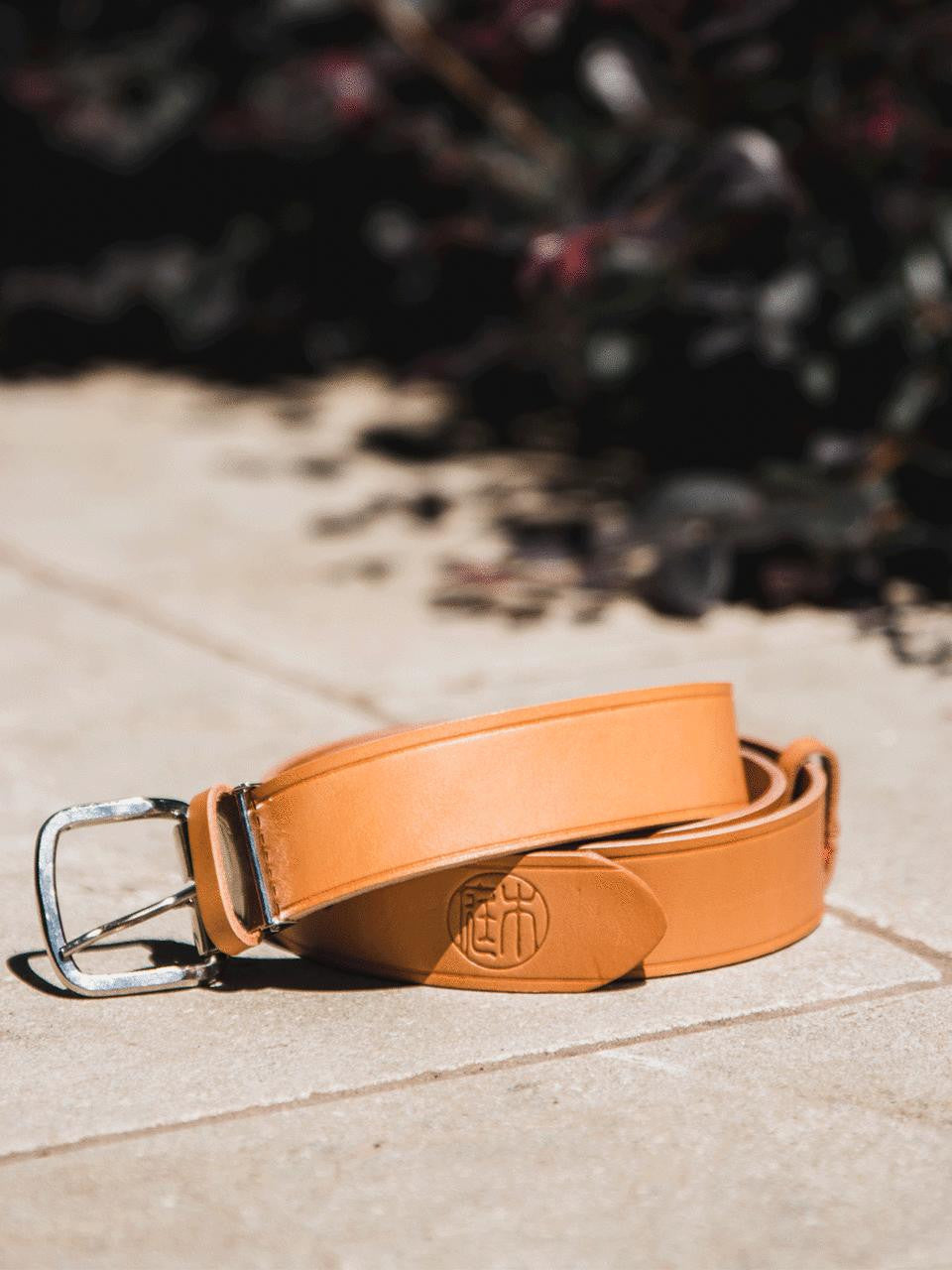 Niwaki tan leather belt with adjustable buckle, showcasing its smooth finish and classic design.