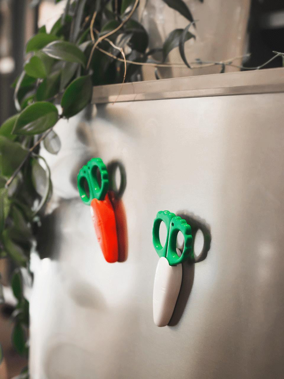 Niwaki Carrot-shaped fridge magnet scissors with a playful design for kitchen or office decor.