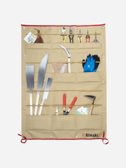 Niwaki canvas tool display with multiple pockets for gardening tools, hanging on a wall for organized storage.
