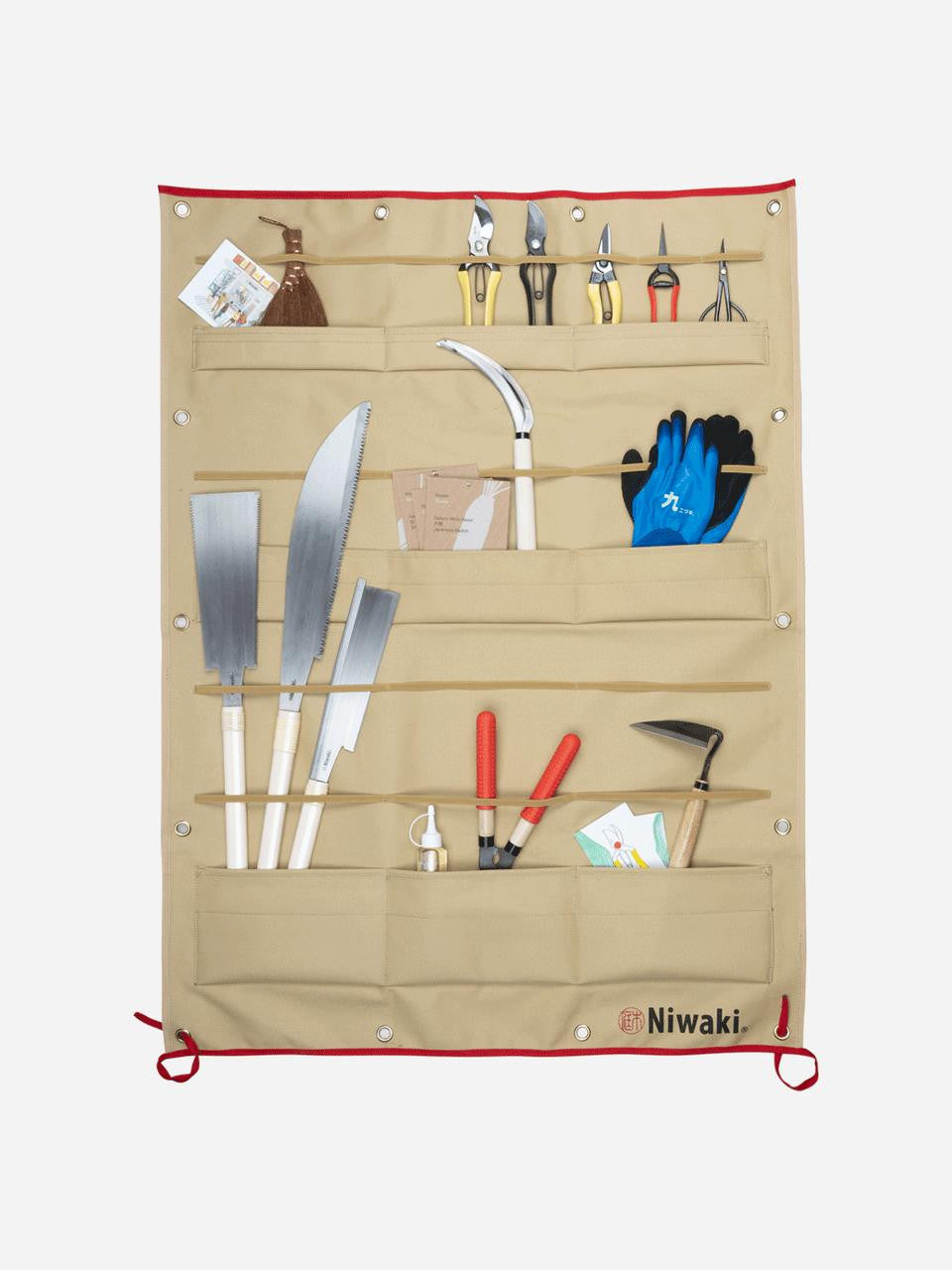 Niwaki canvas tool display with multiple pockets for gardening tools, hanging on a wall for organized storage.