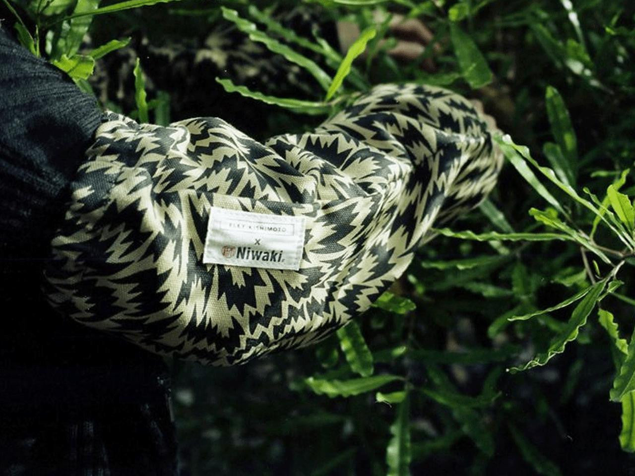 Niwaki Eley Kishimoto X Niwaki Flash Arm Covers showing black fabric arm covers with branding details.