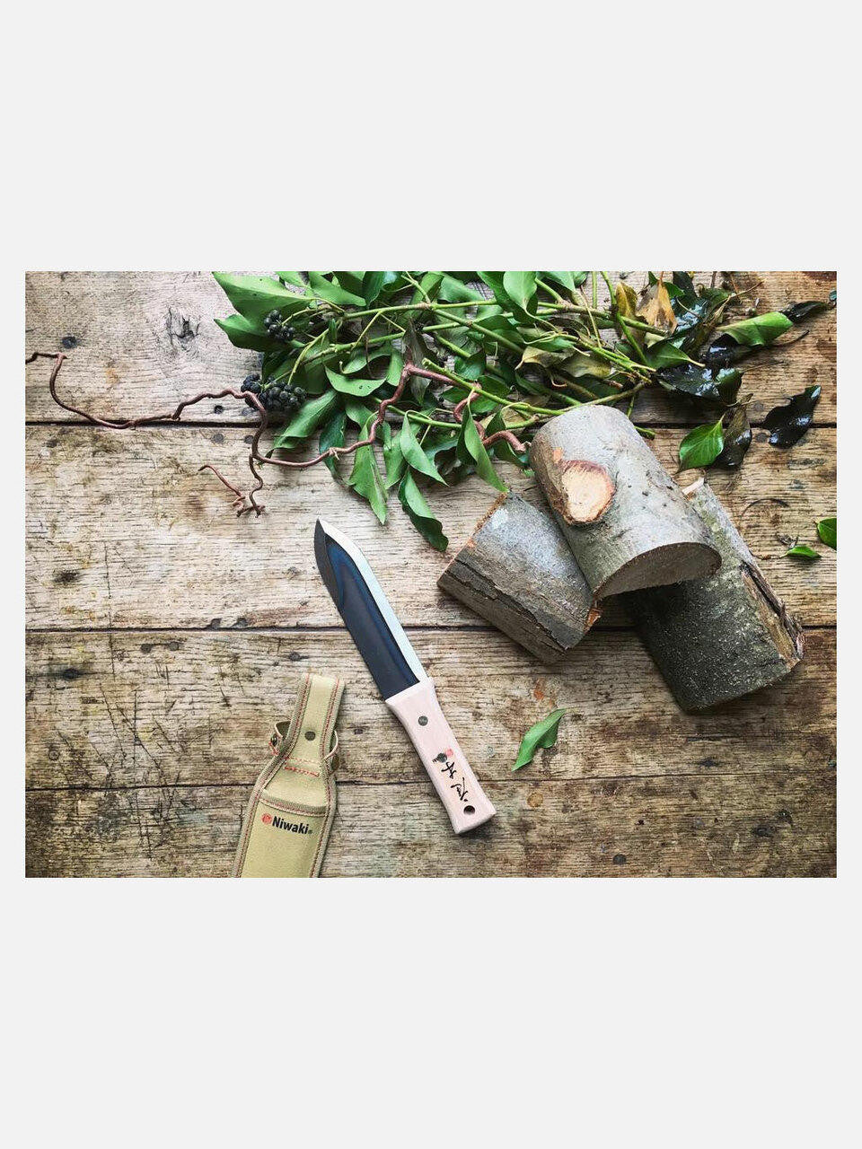 Niwaki Hori Hori Weeder with durable canvas holster, garden tool for digging and weeding, shown with the holster attached.