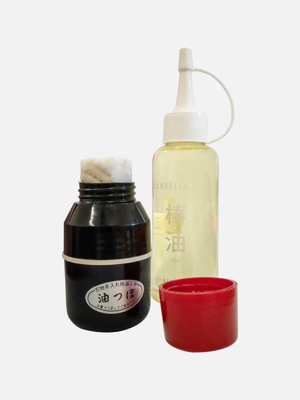 Niwaki oil dispenser with a sleek glass bottle and stainless steel pour spout for kitchen use.