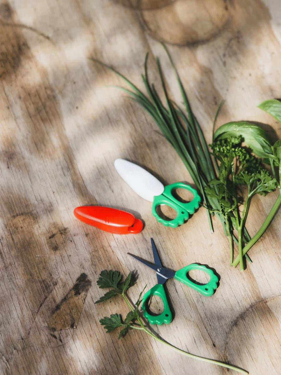 Niwaki fridge magnet scissors shaped like a carrot, made of durable metal, designed for kitchen or office use.