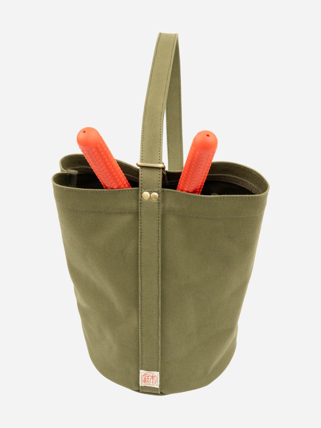 Green Niwaki Mini Kantan Bag with adjustable strap and compact design for carrying small essentials.
