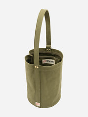 Green Mini Kantan Bag by Niwaki with compact, stylish design and adjustable strap, perfect for carrying small essentials.