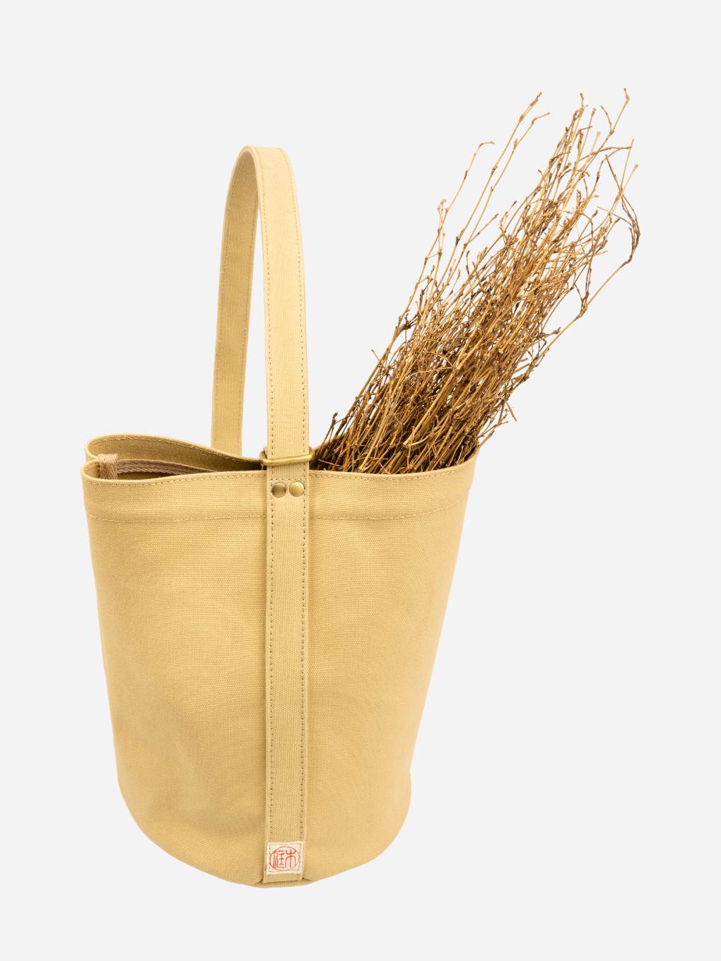 Green Niwaki Mini Kantan Bag with compact design and adjustable strap, perfect for carrying small essentials.