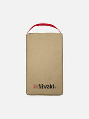 Niwaki kneeler with padded cushion and wooden handles, ideal for gardening comfort and support during outdoor tasks.