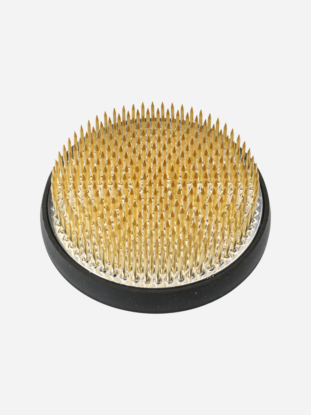 Small Niwaki Kenzan floral arranging pin holder with metal pins for creating ikebana and floral designs.