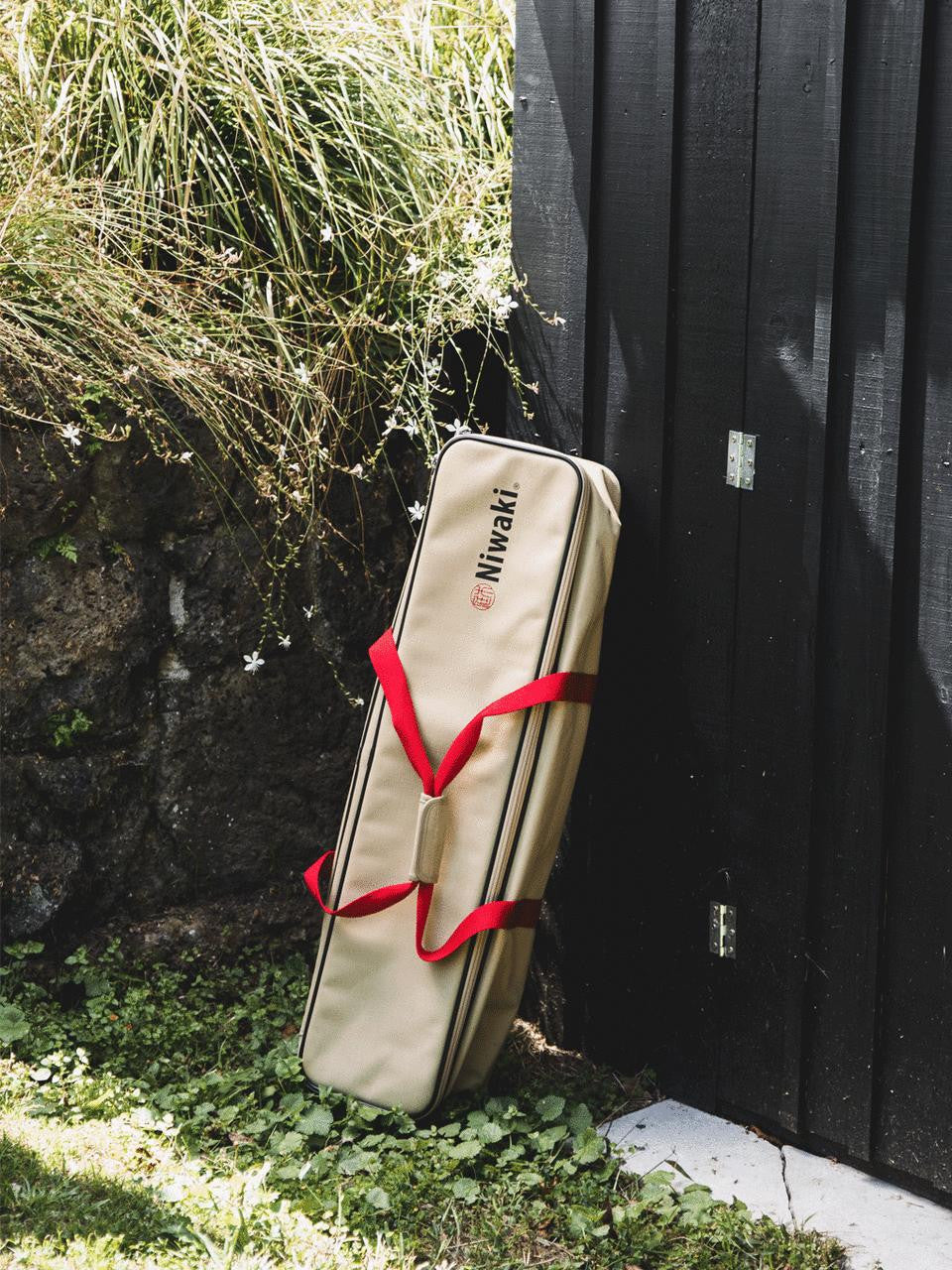 Niwaki tool bag with multiple compartments and handles, made of durable fabric for storing gardening or pruning tools.