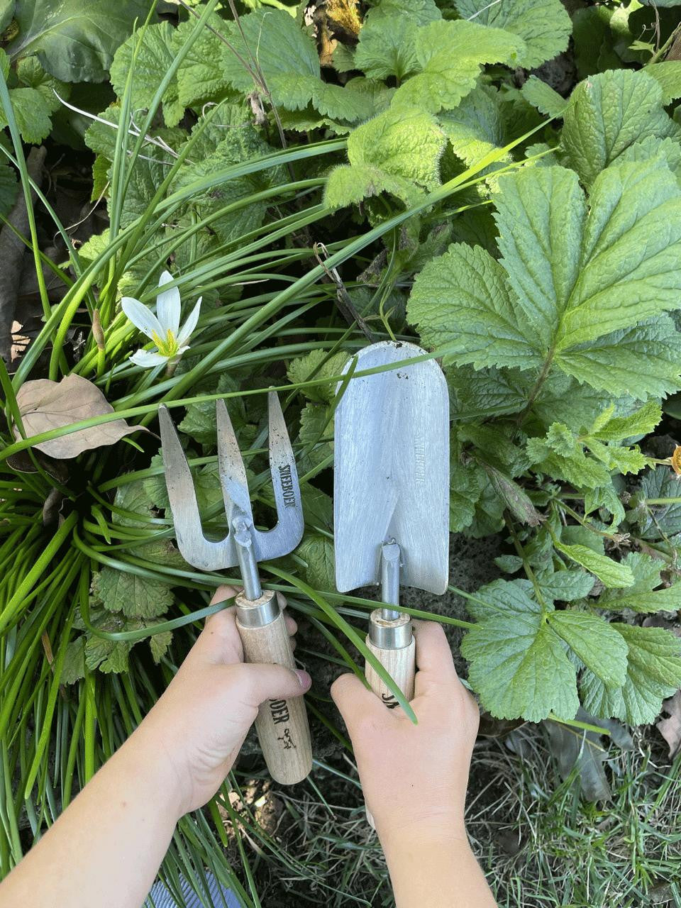 Children's weeding fork by Sneeboer, with small ergonomic handle and stainless steel tines for easy garden weeding.