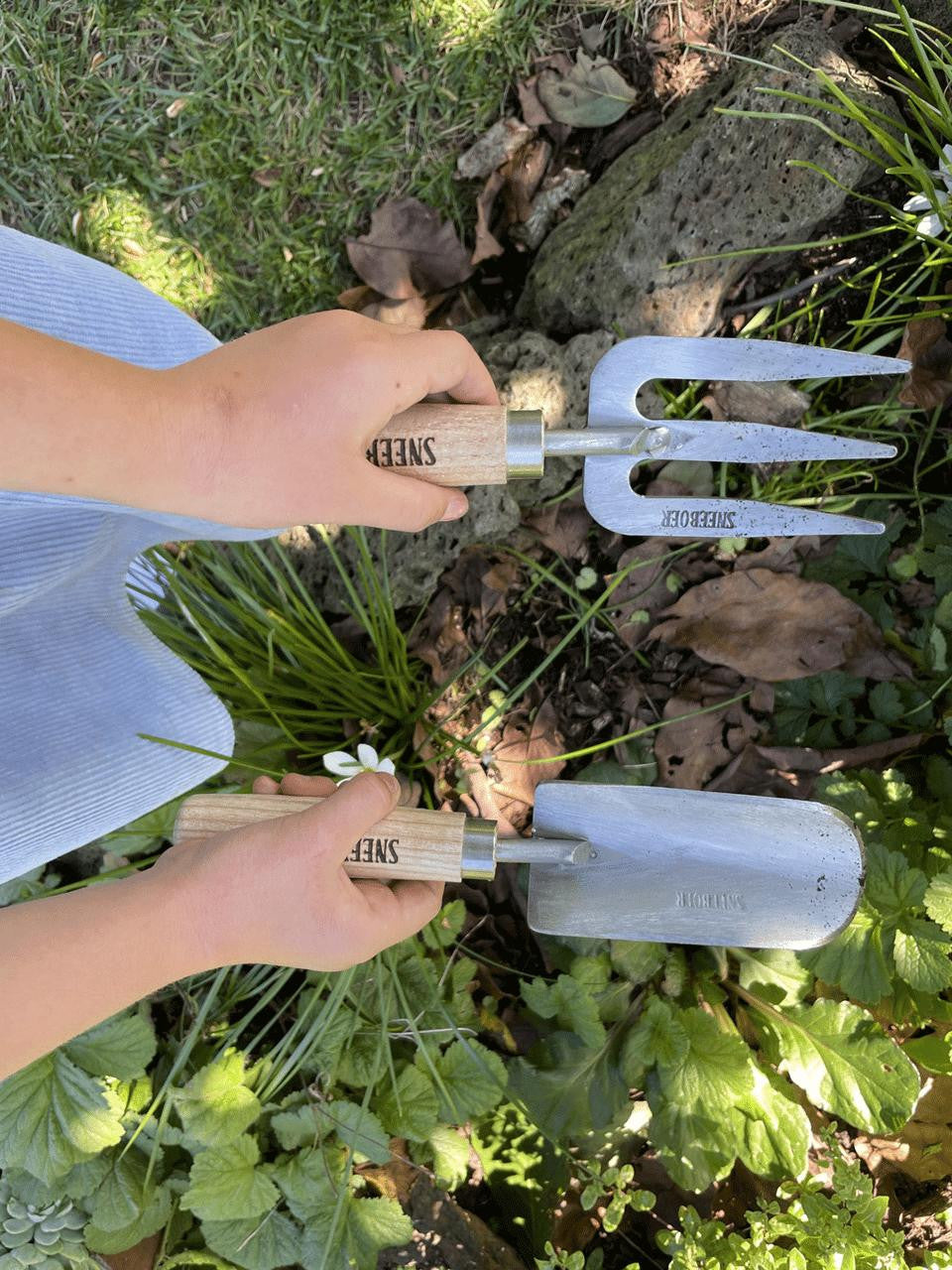 Children's weeding fork by Sneeboer, featuring a small stainless steel tined tool for easy garden weeding for kids.