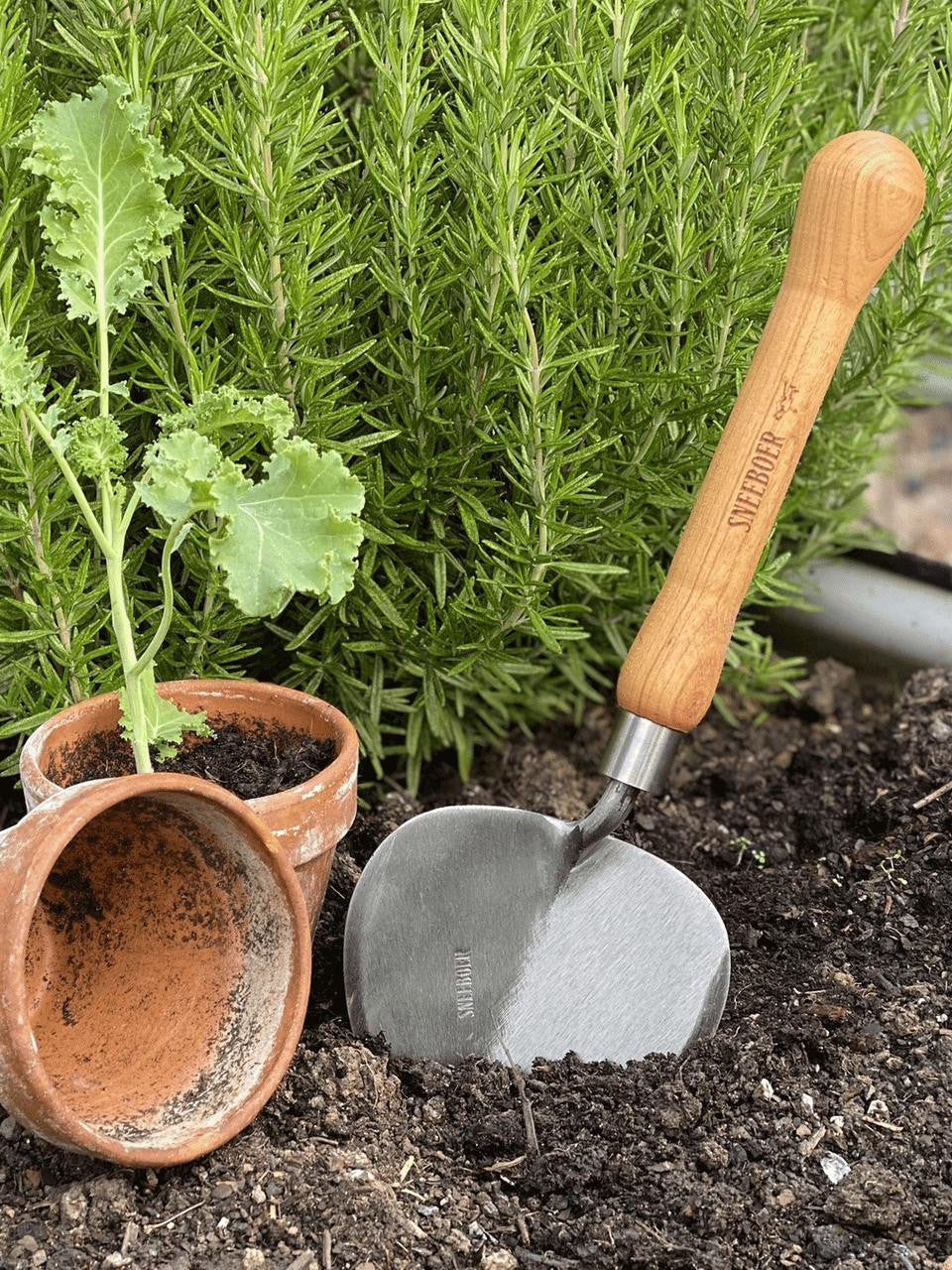 Sneeboer Old Dutch Style planting trowel with wooden handle and stainless steel blade for gardening and planting tasks.